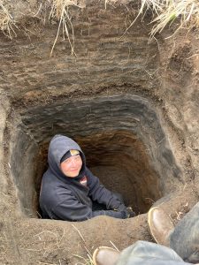 Someone sits at the bottom of a deep hole